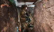 An armed soldier from the 13th Khartiia Brigade of Ukraine's National Guard stands at the...