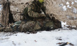 A soldier from the 13th Khartiia Brigade of Ukraine's National Guard administers first aid...
