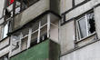 Broken windows in a multi-storey residential building are seen following a Russian drone a...