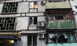 Broken windows in a multi-storey residential building are seen following a Russian drone a...