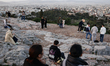A view of the city as people are seen at the Areopagus hill in Athens, Greece on January 7...