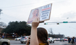 Protesters gather at 45th and Lamar in Austin, Texas, on January 8, 2026, to rally against...