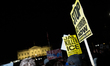 Demonstrators protest in front of the White House in Washington, D.C. on January 8, 2026 a...