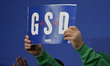 A supporter holds a campaign sign spelling GSD (Get Stuff Done) as Pennsylvania Gov. Josh...