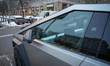 Soviet era buildings are seen reflected in the window of a Tesla Cybertruck in Warsaw, Pol...
