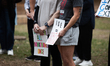 Protesters hold signs that read, ''We were all immigrants once'' and ''ICE = state violenc...