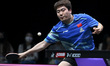 Liang Jingkun of China competes against Lin Shidong of China during a men's singles quarte...