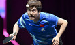 Liang Jingkun of China competes against Lin Shidong of China during a men's singles quarte...