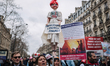 Demonstrators march along a street during a protest called by private doctors to denounce...