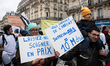 Demonstrators march along a street during a protest called by private doctors to denounce...