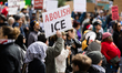 A protester holds a sign that reads, ''abolish ICE'' during a demonstration against Immigr...