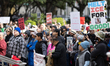 Protesters gather outside City Hall in Houston, Texas, on January 10, 2026, for a demonstr...