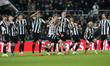 Newcastle United's players react after a near save by Aaron Ramsdale during the penalty sh...