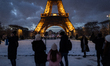 The view of the Eiffel Tower from the Champ de Mars gardens is covered in snow after heavy...