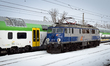 A PKP Intercity EP07 electric locomotive stands next to PESA SUNDECK double-deck passenger...