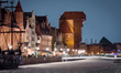 The Long Embankment and the Gdansk Crane are illuminated at night along the Old Motlawa Ri...