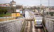 A Porto Metro train emerges from an underground section and heads onto the Dom Luis I Brid...