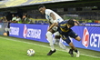 Exequiel Zeballos of Boca Juniors contests the ball with Mosquera of Millonarios of Colomb...
