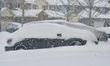 Vehicles are covered in snow as a major winter snowstorm hits in Toronto, Ontario, Canada,...