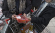 Two Iranian women check the price of meat while shopping for food products at a state chai...