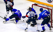Vladislav Pestov of HC Torpedo saves down low as Romain Gutierrez of Angers looks to pounc...