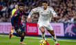 Jude Bellingham of Real Madrid is in action with the ball, defended by Kareem Tunde of Lev...