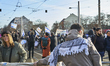 A protester with a keffiyeh stands in the background of a pro-Israel protest at demonstrat...