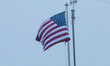 The US flag flies above the U.S. Embassy during a demonstration under the slogans 'hands o...