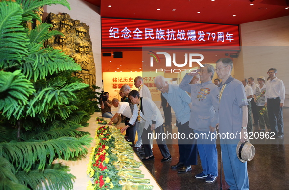 The 92-year-old New Fourth Army veteran Jiao Runkun (2nd R, front) salutes to martyrs at the Museum of the War of Chinese People's Resistanc...