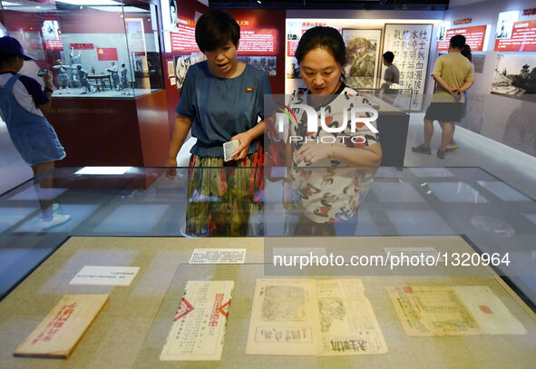People look at the relics during an exhibition at the Museum of the War of Chinese People's Resistance Against Japanese Aggression in Beijin...