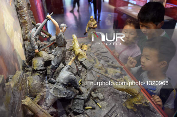 Children visit an exhibition at the Museum of the War of Chinese People's Resistance Against Japanese Aggression in Beijing, capital of Chin...