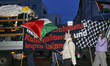 A protester with a Palestine flag participates in a Pro-Palestine demonstration in Leipzig...