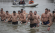 Participants gather after the traditional swim for the cross during the Epiphany celebrati...