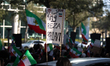 A sign reads, ''Free Iran = King Reza Pahlavi'' during a protest calling for U.S. involvem...