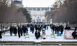 People stroll along the snow-covered Tuileries Gardens after heavy snowfall across the ent...