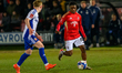 Kelly Nmai of Salford City FC is under pressure from Aidan Borland of Swindon Town FC duri...