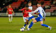 James Ball of Swindon Town FC tackles Kelly Nmai of Salford City FC during the Emirates FA...