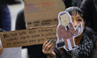 A demonstrator takes part in the placement of a counter marking 98 days of judicial suspen...