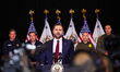 U.S. Vice President JD Vance gives a press conference while standing in front of ICE agent...
