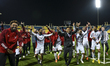 Sharjah head coach, Jose De Morais, and players celebrate after winning the penalty shooto...