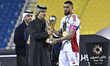 Qatar Football Association President, Jassim bin Rashid Al Buainain, hands the Super Cup Q...