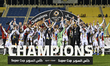 Sharjah players celebrate with the trophy on the podium after winning the Super Cup Qatar-...