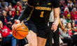 Olivia Olson of the Michigan Wolverines drives the ball during an NCAA women's basketball...