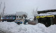In Shopian, Jammu and Kashmir, India, on January 23, 2026, a water tanker is stuck in heav...