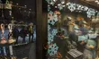 An Iranian family walks past a shop window decorated with snowman dolls at the end of a sn...