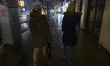 Two Iranian women walk together along a sidewalk at the end of a snowy day in northern Teh...