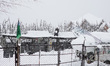 People clear snow from rooftops amid heavy snowfall in Pulwama, South of Srinagar, Indian...