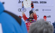 Marco Odermatt of Switzerland stands on the podium in second place at the HKR Downhill dur...