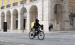 A person on a bike rides during daily activities in Lisbon, Portugal, on January 24, 2026,...