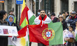 A person carries some flags and shouts political slogans during a march in downtown Lisbon...